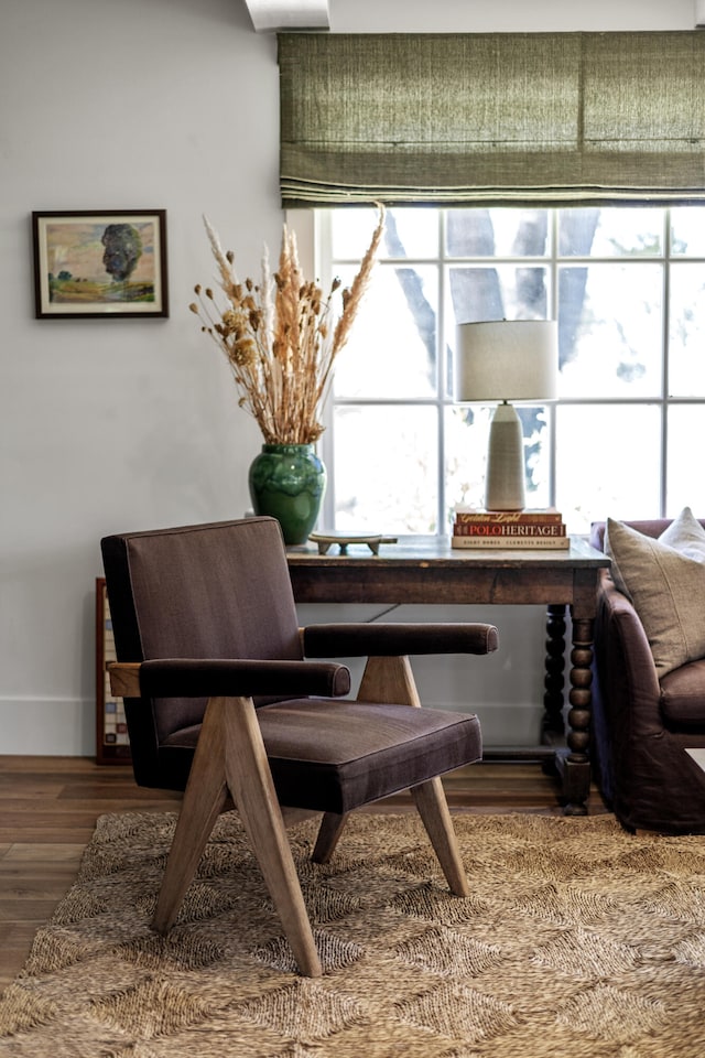 living area with plenty of natural light and hardwood / wood-style floors