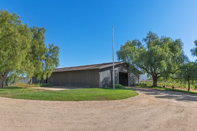 view of outdoor structure featuring a lawn