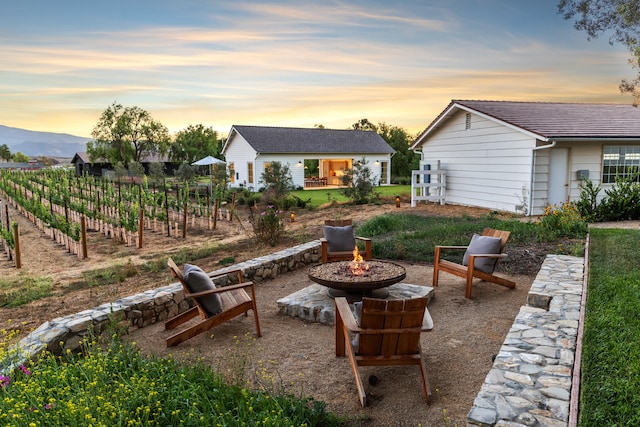 patio terrace at dusk with an outdoor fire pit