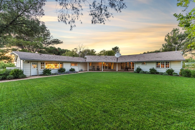 single story home with a lawn