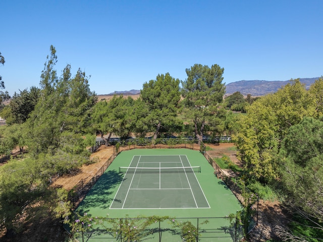 view of tennis court with a mountain view