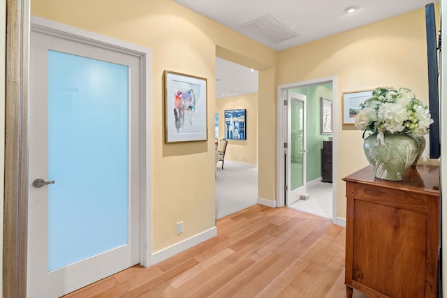 hall with light hardwood / wood-style flooring