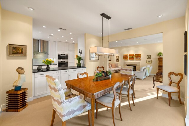 dining area with light colored carpet