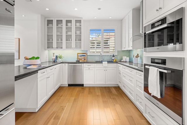 71 Seaview Dr, Santa Barbara, CA 93108 - kitchen featuring a sink, dark countertops, white cabinetry, glass insert cabinets, and recessed lighting