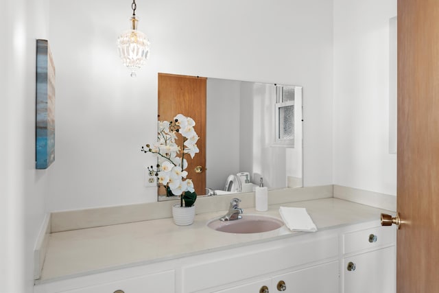 bathroom with a chandelier and vanity