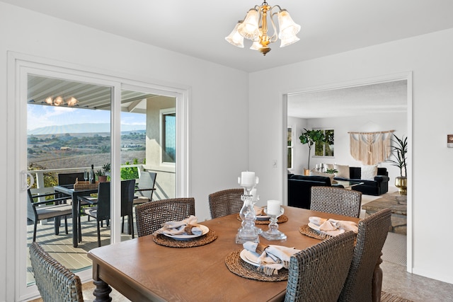 dining area featuring a notable chandelier and a mountain view