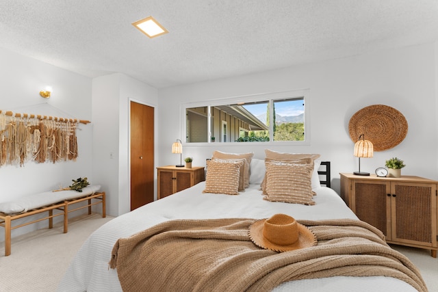 carpeted bedroom with a textured ceiling