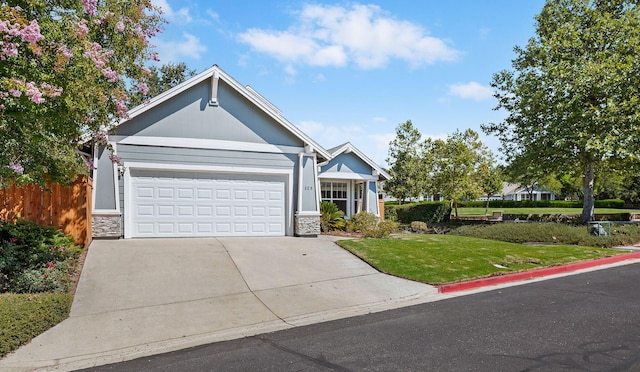 view of front of property with a garage and a front lawn