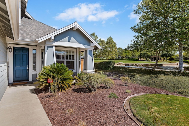 entrance to property featuring a yard