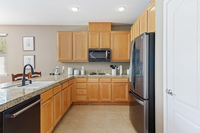 kitchen featuring sink, kitchen peninsula, appliances with stainless steel finishes, light brown cabinets, and light tile patterned floors