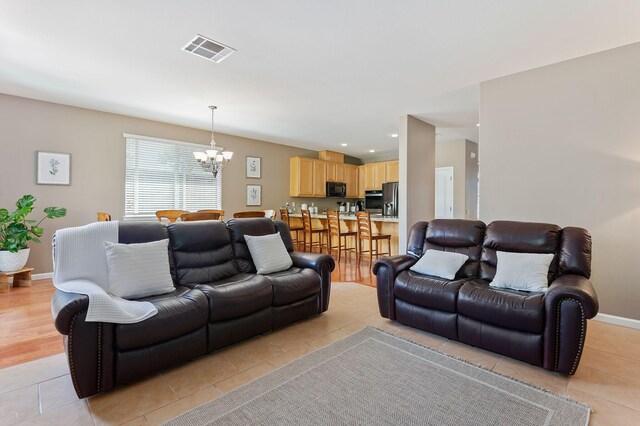 320 Savanna Dr, Los Alamos, CA 93440 - living room featuring a chandelier, light tile patterned flooring, and baseboards