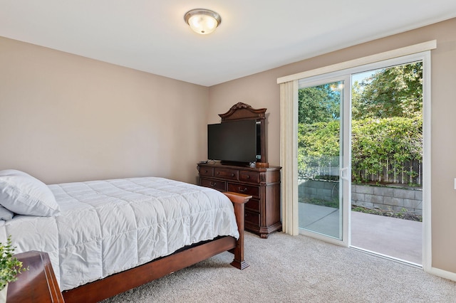 bedroom with access to outside and carpet flooring