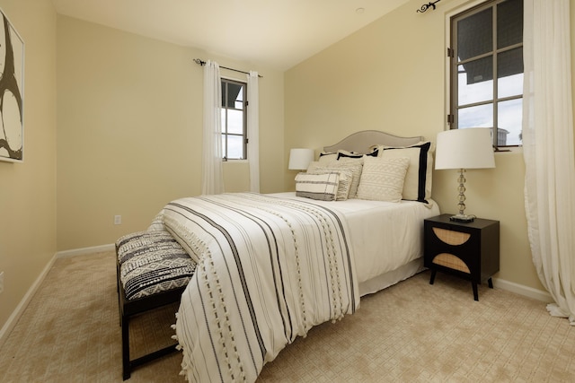 carpeted bedroom with lofted ceiling