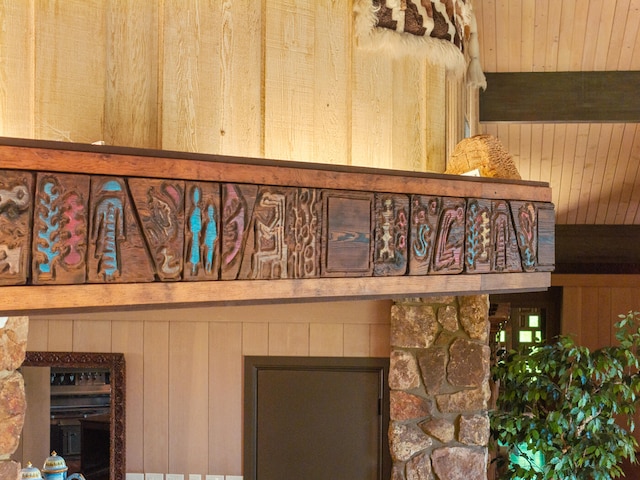 details featuring wood walls, wooden ceiling, and beam ceiling