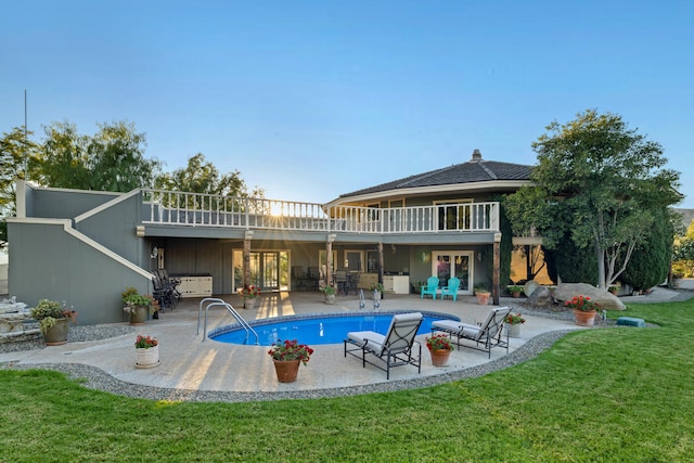 back of property featuring a patio area and a yard