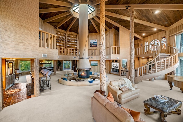 living room with high vaulted ceiling, carpet floors, beamed ceiling, and wood ceiling