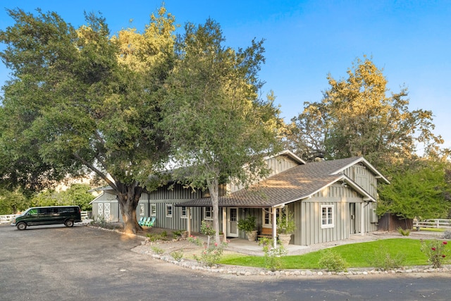 view of front facade with a front lawn and a storage unit