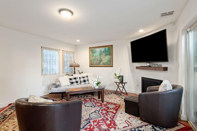 living room with hardwood / wood-style floors and a healthy amount of sunlight