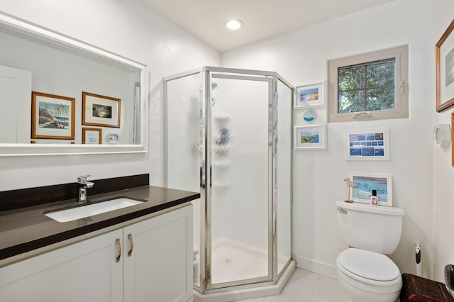 bathroom featuring tile patterned floors, a shower with door, vanity, and toilet