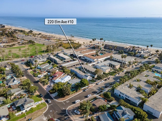 birds eye view of property with a water view and a view of the beach