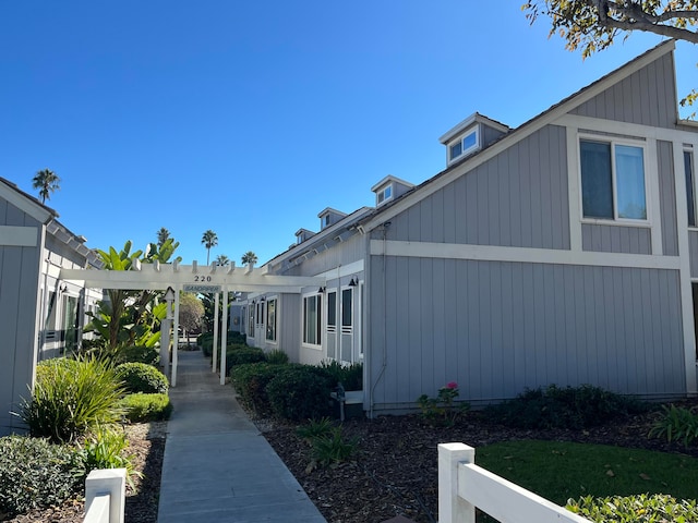 view of side of home featuring a pergola