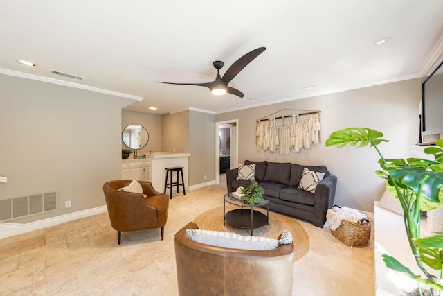 living room with ceiling fan and crown molding