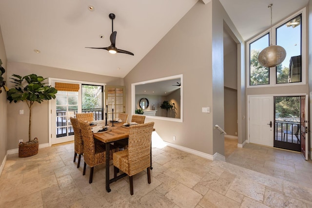 dining space featuring ceiling fan and high vaulted ceiling