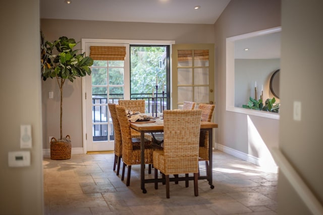 dining space featuring vaulted ceiling