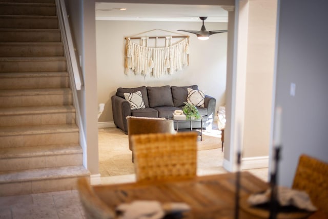 living room featuring ceiling fan, tile patterned floors, and ornamental molding