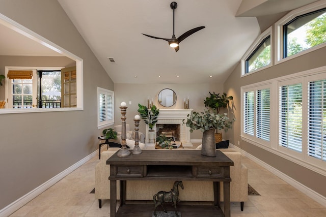 dining space featuring a brick fireplace, a healthy amount of sunlight, and light tile patterned floors