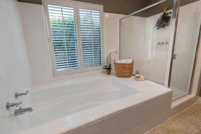 bathroom featuring tile patterned floors and separate shower and tub