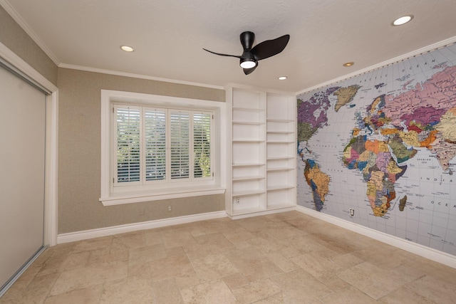 spare room with ornamental molding and ceiling fan