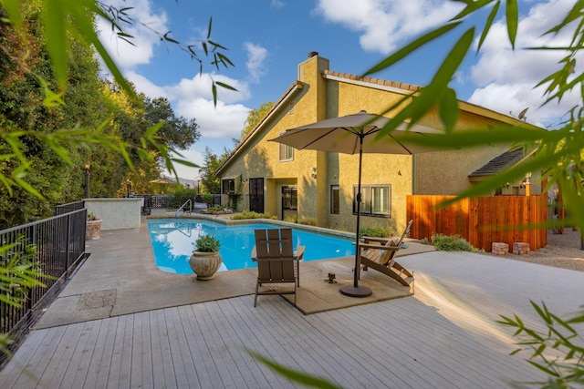 view of swimming pool with a deck