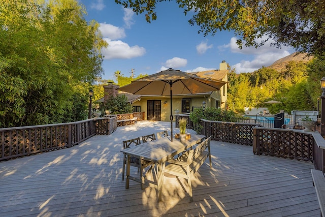 deck with a swimming pool and a mountain view