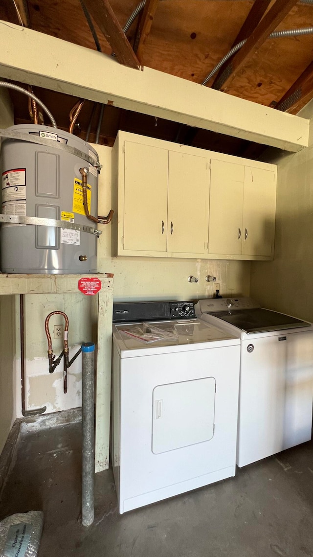 washroom with cabinets and washing machine and clothes dryer