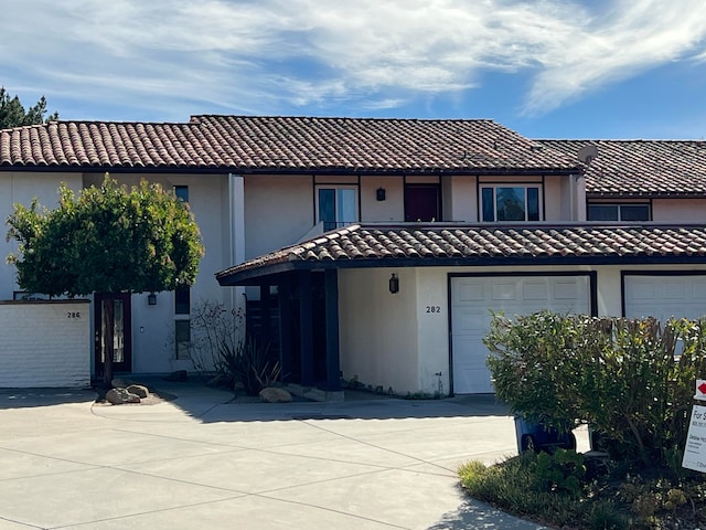 mediterranean / spanish house with a garage