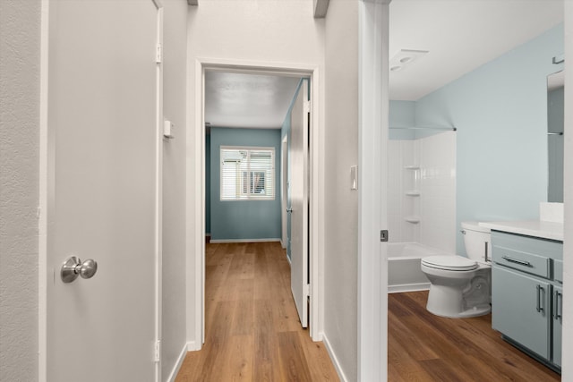 full bathroom featuring vanity, hardwood / wood-style flooring, tub / shower combination, and toilet