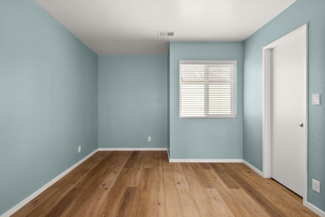 spare room featuring light hardwood / wood-style flooring