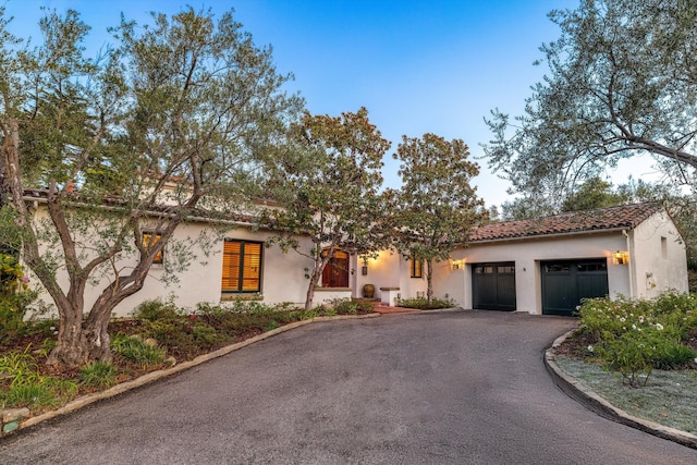 mediterranean / spanish-style house featuring a garage