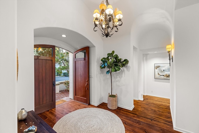 entrance foyer with dark hardwood / wood-style flooring and a chandelier