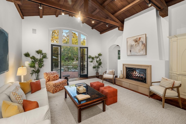 living room featuring beam ceiling, high vaulted ceiling, and wooden ceiling