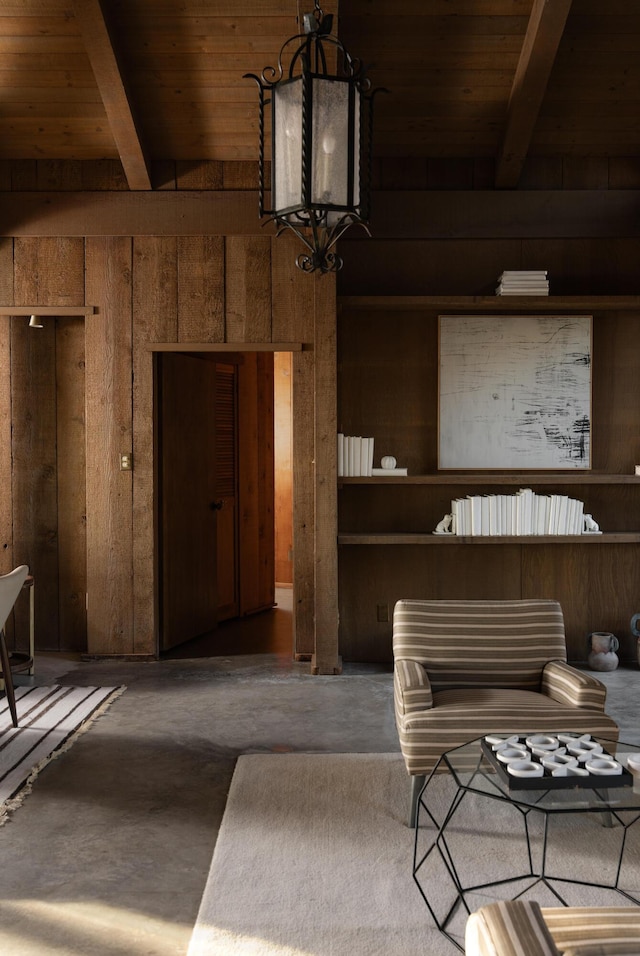 interior space with beam ceiling, wooden ceiling, concrete floors, and wood walls