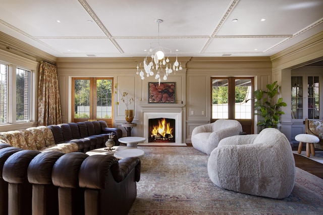 5200 Armour Ranch Rd, Santa Ynez, CA 93460 - living room featuring healthy amount of natural light, a chandelier, coffered ceiling, a lit fireplace, and a decorative wall