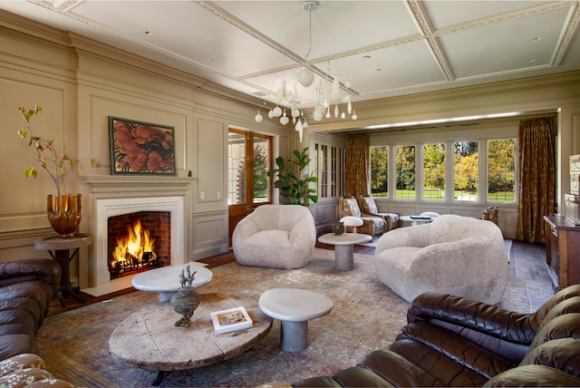 living room featuring wood-type flooring, ornamental molding, and coffered ceiling