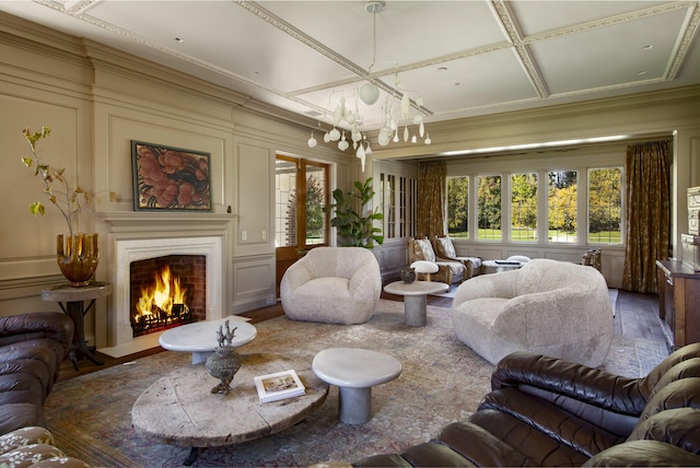 5200 Armour Ranch Rd, Santa Ynez, CA 93460 - living area featuring a fireplace with flush hearth, a chandelier, wood finished floors, a decorative wall, and crown molding