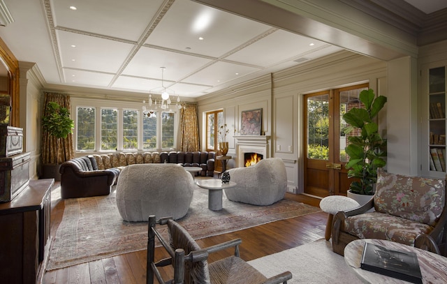 5200 Armour Ranch Rd, Santa Ynez, CA 93460 - living area with plenty of natural light, wood-type flooring, a warm lit fireplace, a chandelier, and coffered ceiling