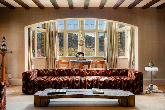 living room with beam ceiling and light wood-type flooring