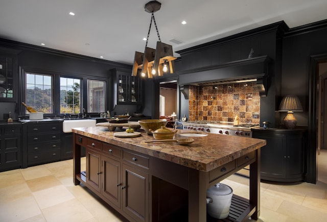 5200 Armour Ranch Rd, Santa Ynez, CA 93460 - kitchen with backsplash, a kitchen island, recessed lighting, stainless steel gas cooktop, and glass insert cabinets