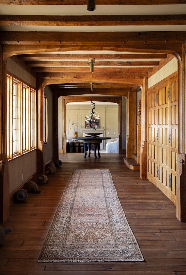 5200 Armour Ranch Rd, Santa Ynez, CA 93460 - hallway featuring arched walkways, dark wood-style flooring, and beam ceiling