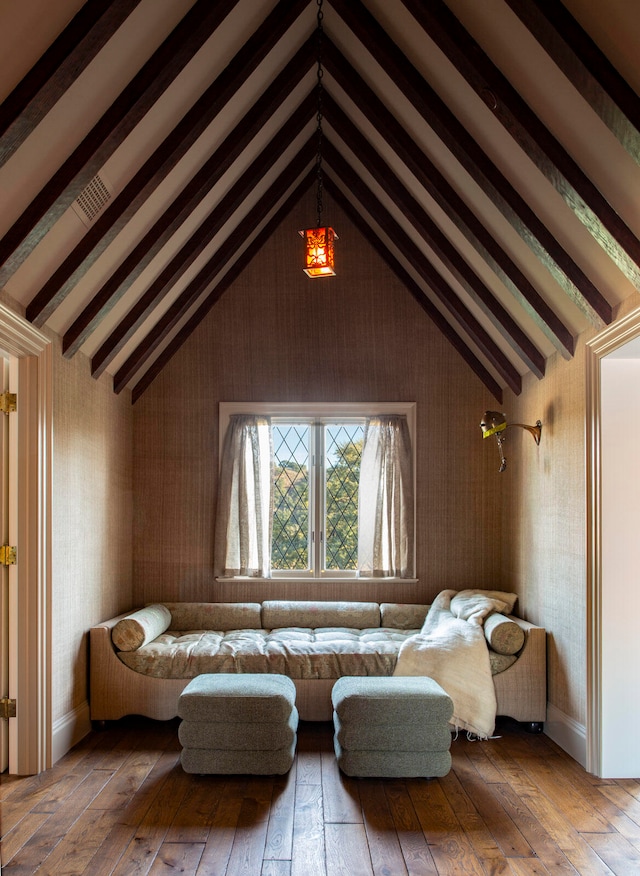 living room featuring vaulted ceiling with beams and wood-type flooring